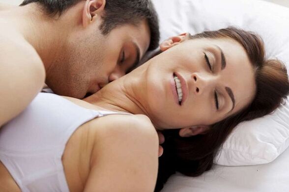 A person in bed and a woman